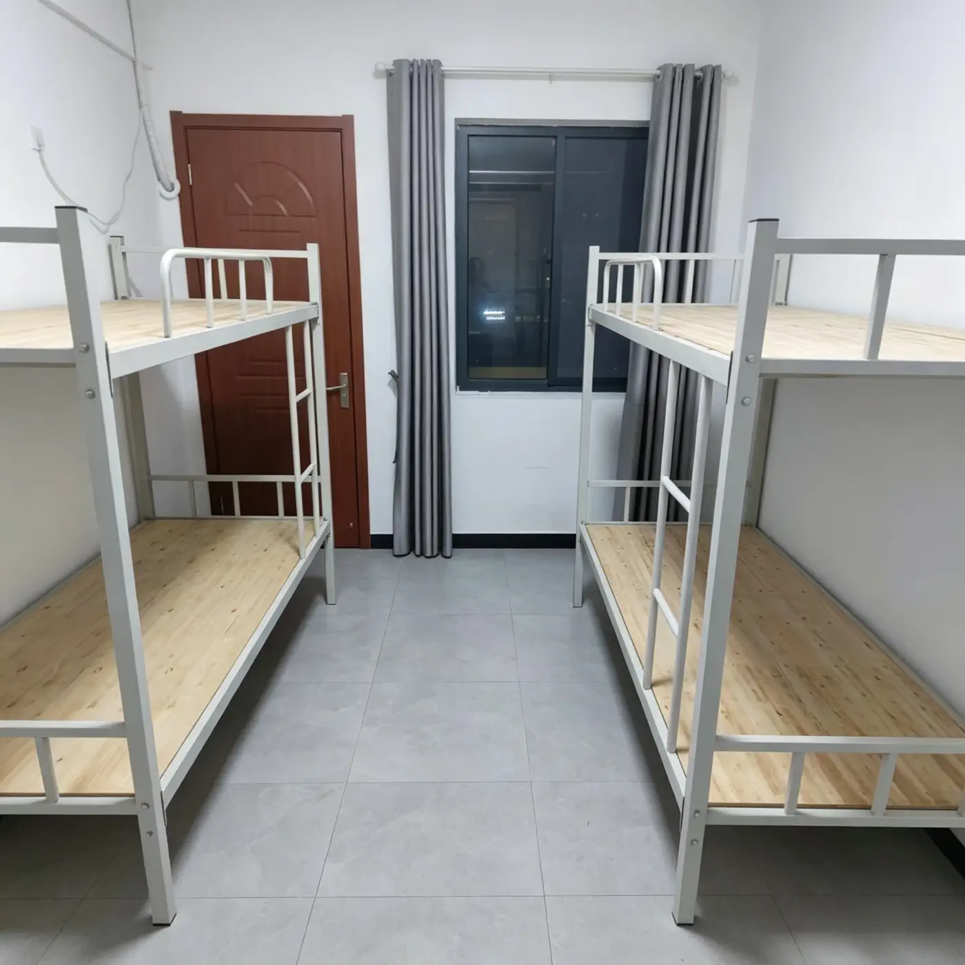 Worker dormitory room with bunk beds curtains and efficient space planning for privacy